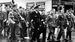 German prisoners of war marching through the streets of Gravenhurst, Ontario, on their way from the train station to the prisoner of war camp.